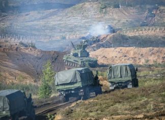 Vladimir Putin watches display of Russian firepower near EU border